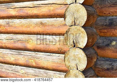 Texture Of Wall Of House Made Of Rounded Logs. Facade Of Log House, Space For Text. Wooden Log Wall 