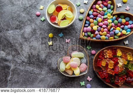 Multicolored Candies, Dragees And Jelly On A Black Background