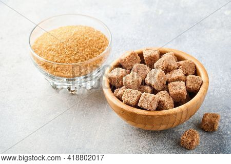 Cane Sugar Cube In Bamboo Bowl On Gray Table Concrete Background. Top View.