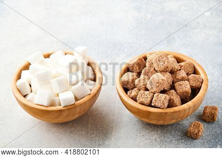 Cane Sugar And White Sugar Cube In Bamboo Bowl On Gray Table Concrete Background. Selective Focus.