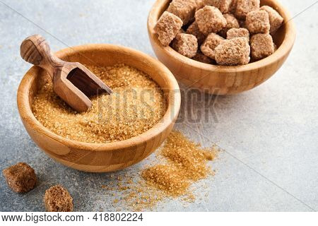 Cane Sugar Cube In Bamboo Bowl On Gray Table Concrete Background. Top View.
