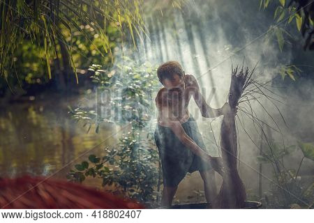 Vietnamese Old Man Craftsman Dyeing The Traditional Vietnam Mats In The Old Traditional Village At D