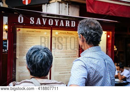 Annecy, France - Aug 15, 2017: Rear View Of Customers Reading Menu At The O Savoyard Restaurant Menu