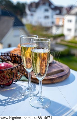Drinking Of Brut Champagne Sparkling Wine In Flute Glasses On Outdoor Cafe Or Bistro Terrace In Fran