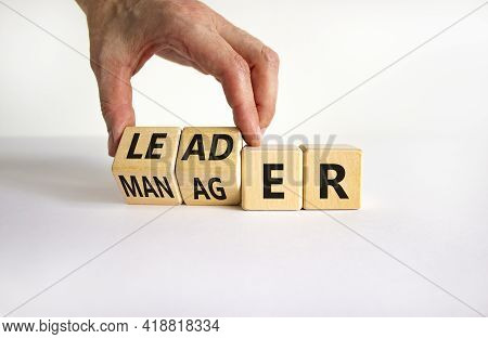 Manager Versus Leader Symbol. Businessman Turns Wooden Cubes And Changes The Word 'manager' To 'lead