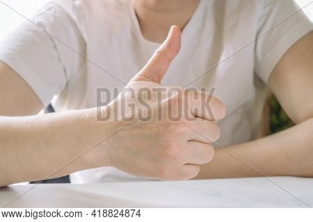 Close-up Of A Hand Thumb Up. Gesture Of Approval Signifying That Everything Is Fine. An Indecent Ges