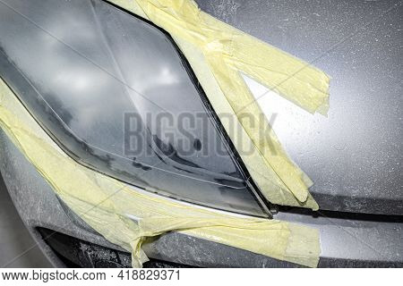 The Headlight Is Covered With Abrasive Paste And Secured With A Protective Tape, Prepared For Polish