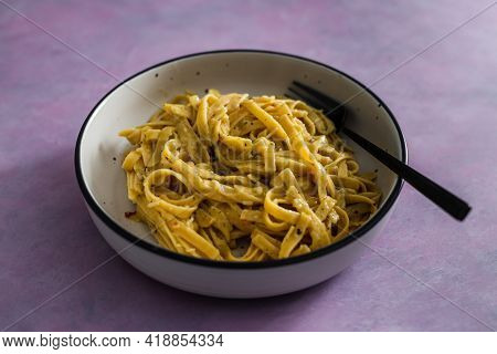 Vegan Lemon And Herbs Sauce Fettuccini Pasta On Pink Background, Healthy Plant-based Food