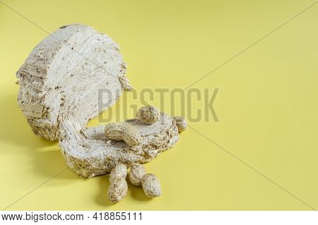 Peanut Halva With Peanut Decor On The Bright Yellow Background Of The Mine Space. Halva Of Oriental 