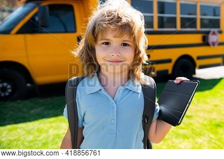 Portrait Of Happy Little Schoolboy Pupil Outdoor On School Bus.