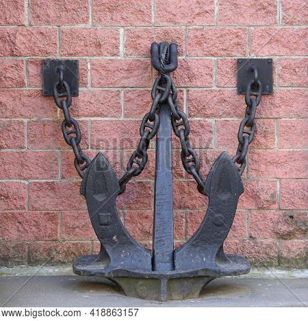 Decorative Black Metal Anchor Attached By Chains To The Pink Wall, Ulitsa Antonova-ovseenko 18, Sain