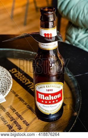 Madrid, Spain - April 24 - 2021: Bottle Of Mahou Beer Cinco Estrellas Or Five Stars On Table Of Bar