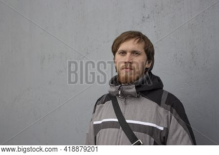 Young Caucasian Male 30 Years Old In A Gray Jacket. Mujina With A Beard And Mustache, Blonde Hair, C