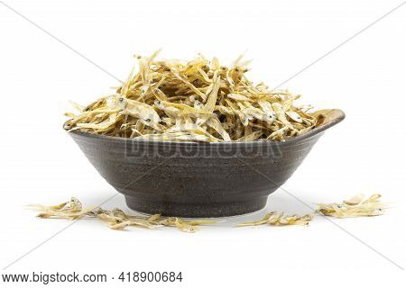 Dry Anchovy (stolephorus Indicus) Fish In Ceramic Bowl Isolated On White Background.