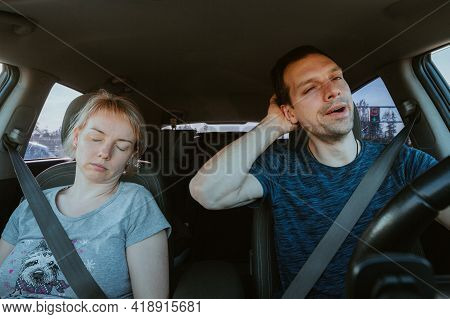 Grane Effect. Tired Yawning Man Driving A Car And Sleeping Woman Together During Road Trip. Passenge