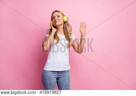 Photo Of Nice Optimistic Blond Lady Dance Listen Music Wear White T-shirt Jeans Isolated On Pink Col