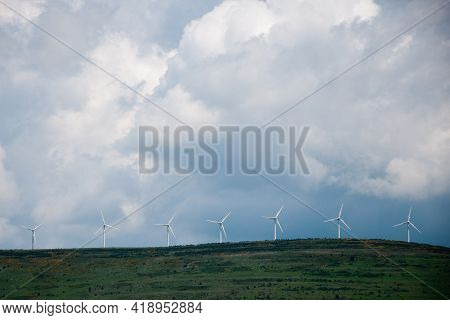 Impresive Cloudy Sky Over A Hill With Wind Turbines In A Row. Soria, Castilla, Spain