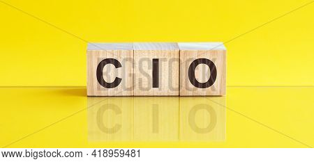 Cio Word Written On Wood Block. Cif Word Is Made Of Wooden Building Blocks Lying On The Yellow Table