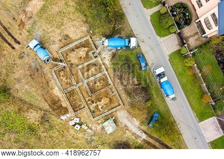 Top Down Aerial View Of Construction Works Of New House Concrete Foundation In Rural Residential Are