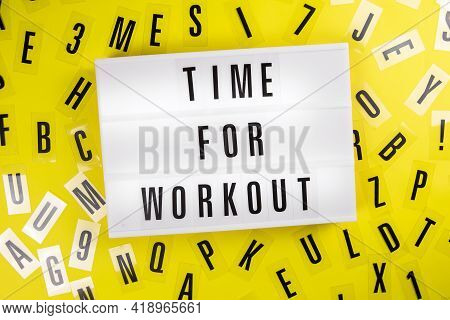 Lightbox With Text Time For Workout On Yellow Background With Black Letters Randomly Scattered. Conc