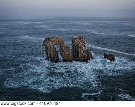 Panorama View Of Urro Del Manzano Rock Formation Sea Stack Natural Arch Bridge In Liencres Arnia Cos