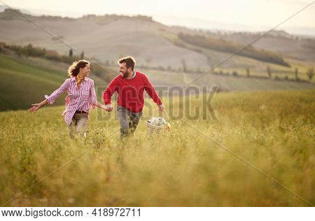 Affectionate couple enjoying a beautiful day outisde on meadow