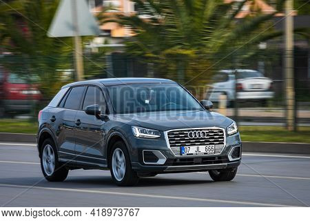 Alanya, Turkey - April 16 2021:   Audi Q2  Is Driving Fast On The Street On A Warm Summer Day Agains