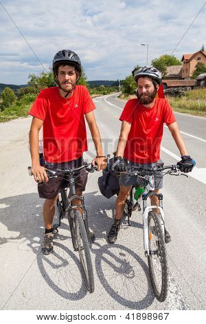 MOSTAR, BOSNIA - AUGUST 14: Young cyclist touring from Madrid to Istanbul on August 14, 2012 near Mostar, Bosnia. A growing number of eco-travellers tour by bike to lessen their carbon footprint.