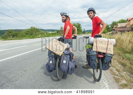 MOSTAR, BOSNIA - AUGUST 14: Young cyclists touring from Madrid to Istanbul on August 14, 2012 near Mostar, Bosnia. A growing number of eco-travellers tour by bike to lessen their carbon footprint.