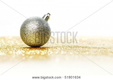 Silver christmas ball on shiny golden background