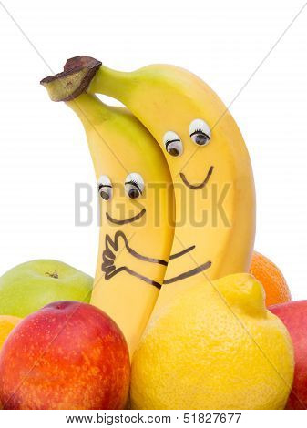Two loving bananas between other fruit
