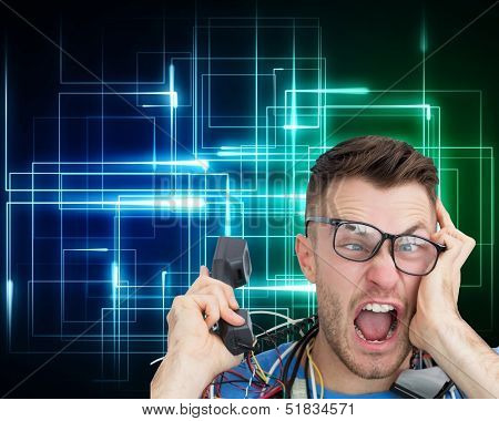 Composite image of frustrated computer engineer screaming while on call on black background with glowing lines