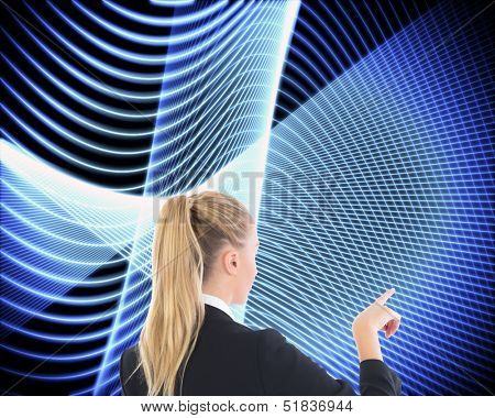 Composite image of businesswoman pointing somewhere on black background with glowing blue lines