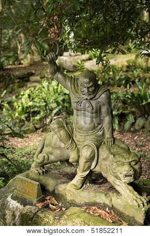 Old ruined Arhat Kanakbharadvaja statue in forest, Taiwan, Asia.