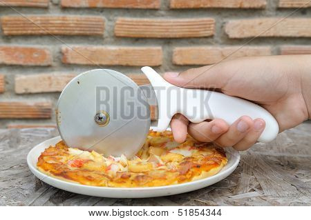 cutting tasty pizza