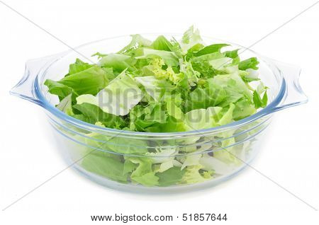 a glass bowl with mesclun, a mix of assorted salad leaves, on a white background
