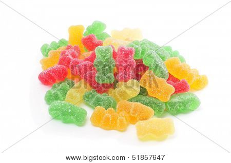 a pile of gummy bears of different colors on a white background