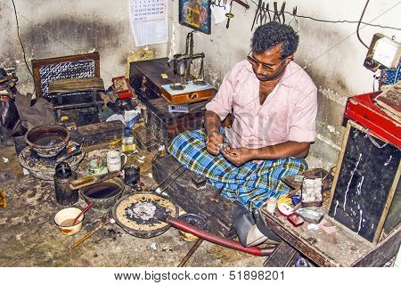 Silver Smith At Work In His Shop
