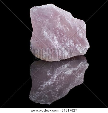 Natural Rose Quartz crystal with reflection on black surface background 