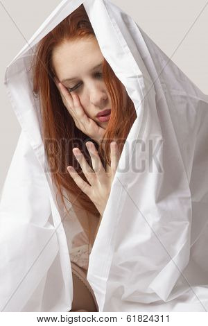 virginal red hair woman with hands in her face