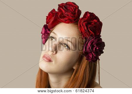 beautiful young woman  with red Hair and red roses hairstyle