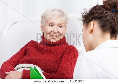 Elderly Lady Listening To Nurse