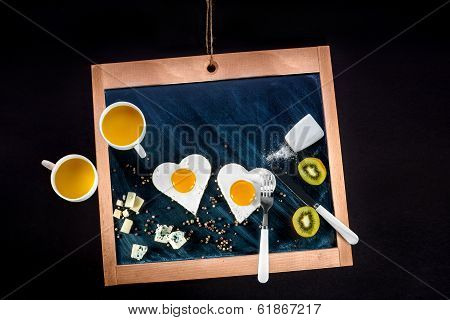 Breakfast With Eggs, Cheese, Kiwi And Orange Juice On Chalkboard With Space For Your Text