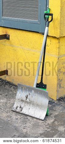 Tools For Territory Cleaning. Shovel And Sweeper Leaned Against A Wall.