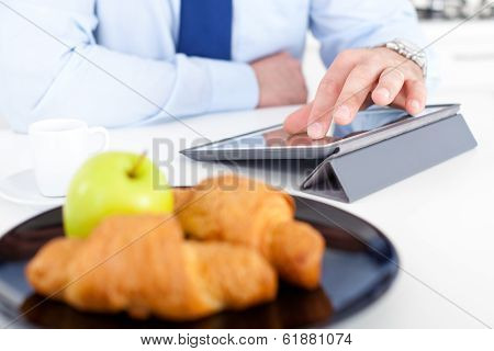 Businessman With Tablet At Breakfast