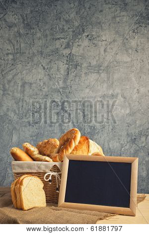 Delicious Bread And Rolls In Wicker Basket