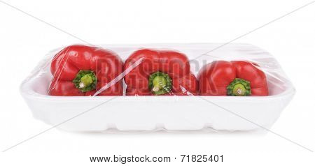 Pepper packed in food film isolated on white 