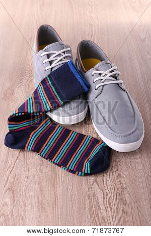 Top-Siders and socks on wooden background