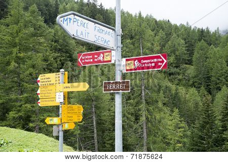 FERRET, SWITZERLAND - AUGUST 30: Tour du Mont Blanc direction signs. The popular tour goes through France, Italy and Switzerland, and is clearly signalised throughout.. August 30, 2014 in Ferret.