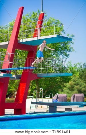 Boy Jumping Into A Pool